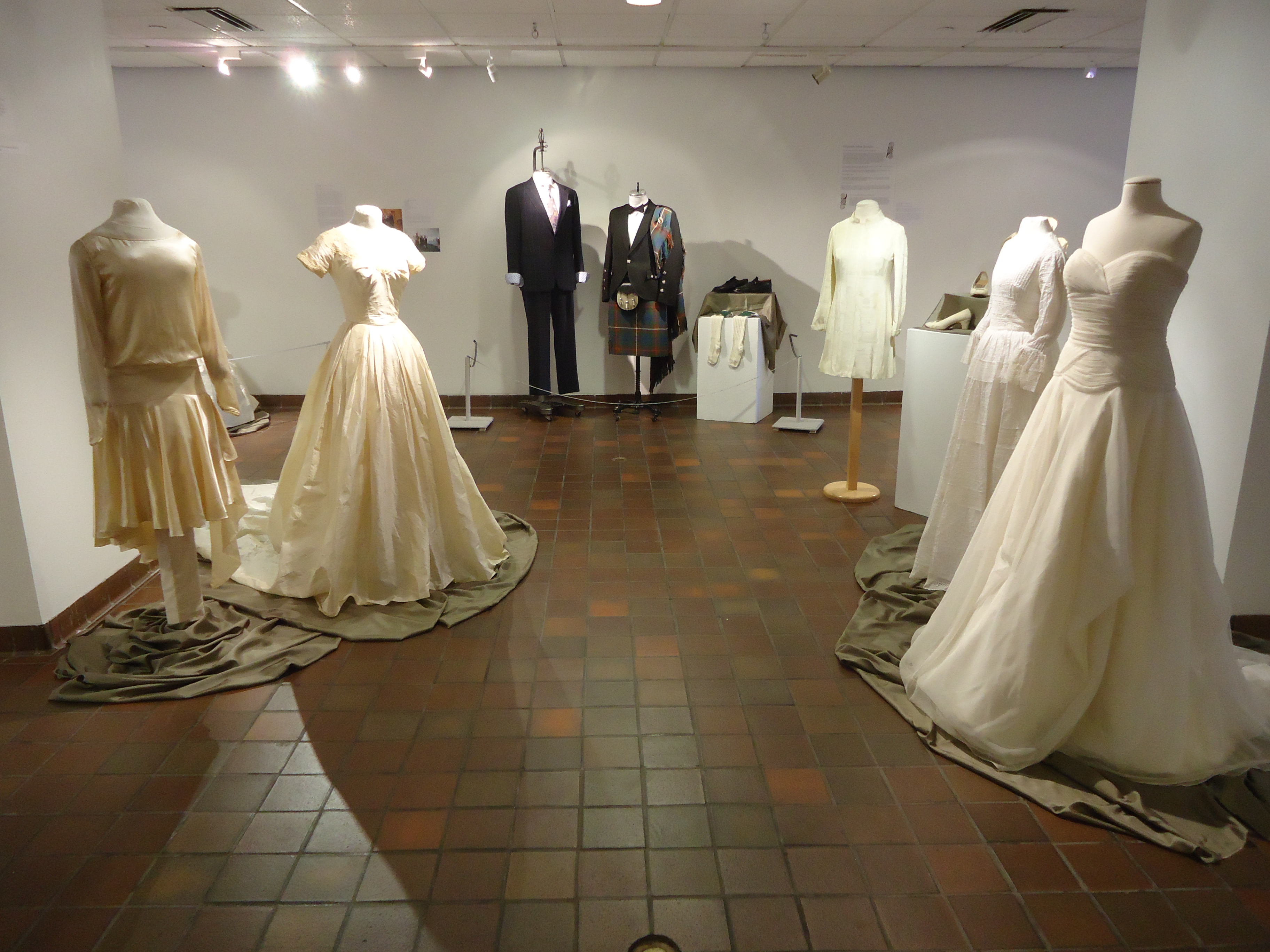 an image of 5 very different wedding dresses and 2 groom's outfits
